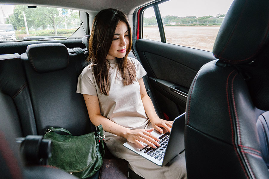 Woman Working in the back of a Car